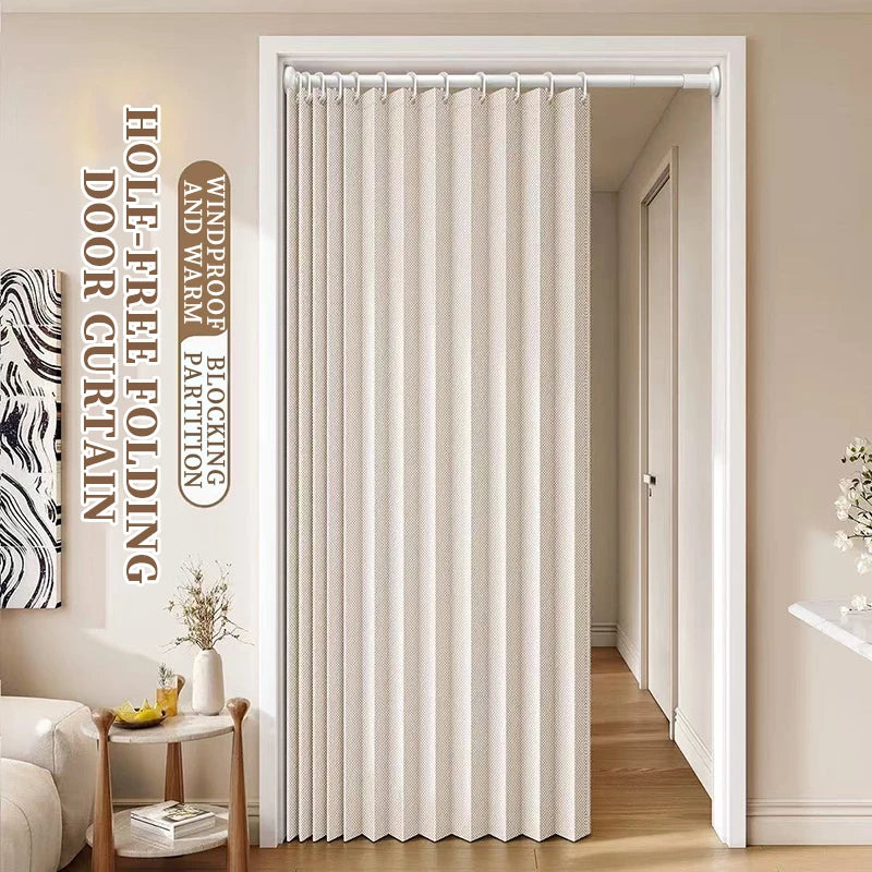 A floor-length beige folding curtain hanging in a white door frame.
