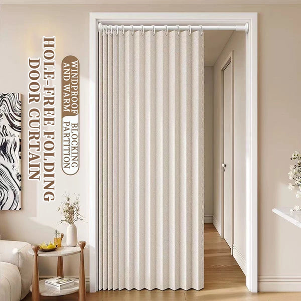 A floor-length beige folding curtain hanging in a white door frame.