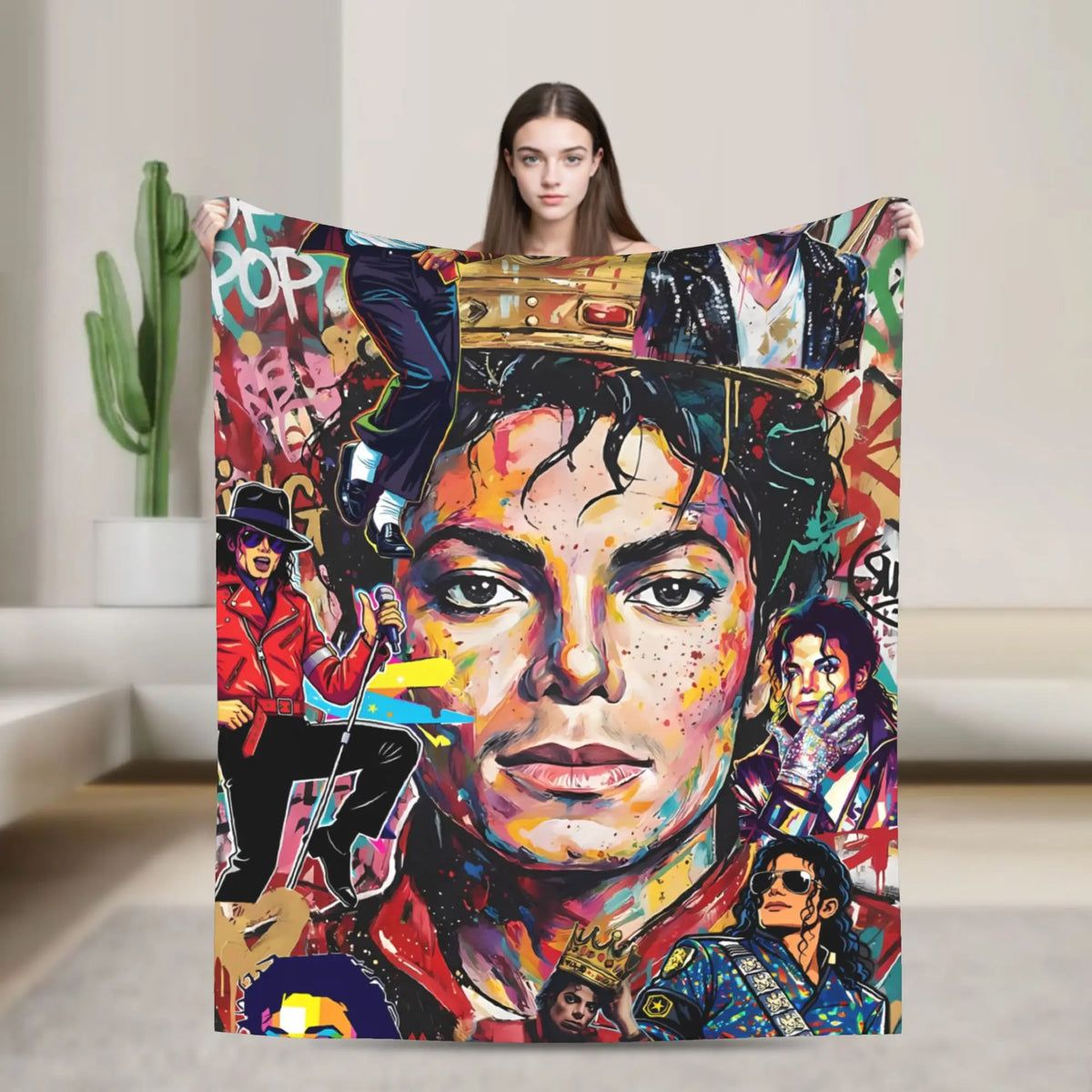 A person holds up a colorful graphic plush throw blanket featuring a portrait of a musician.