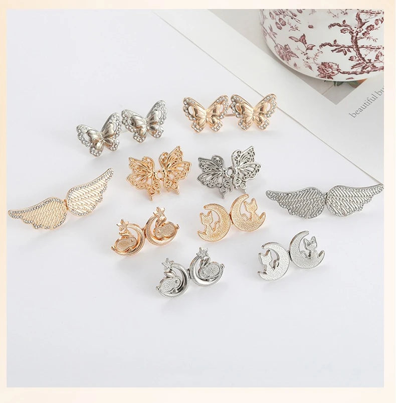 A collection of silver and gold butterfly buttons used as an adjustable waist tightener for clothing.