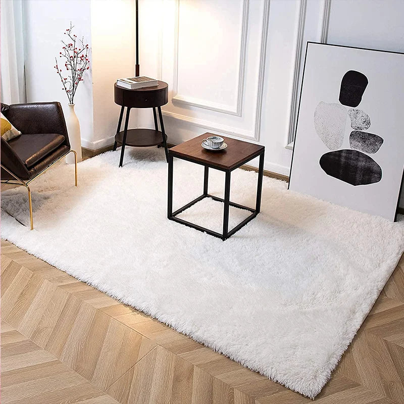 A white fluffy rug in a modern Nordic style placed on a light wood floor with minimalist decor.