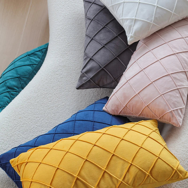 A collection of decorative pillow covers in various shades including teal, gray, pink, and yellow.