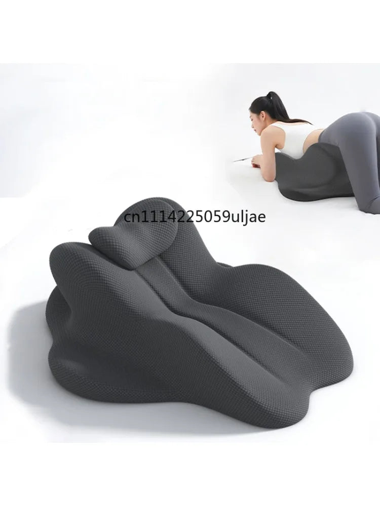 A dark gray ergonomic memory foam pillow designed for back and head support, shown in use.