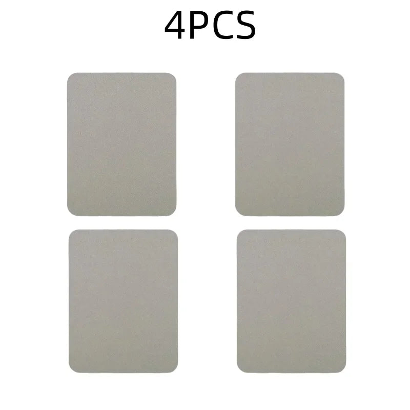 Four square gray iron-on fabric repair patches laid out on a white background.