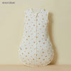 A white cotton sleep sack for baby or toddler with small gold heart embroidery.