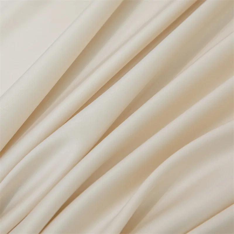 Soft beige luxury bamboo flat sheets draped in flowing fabric