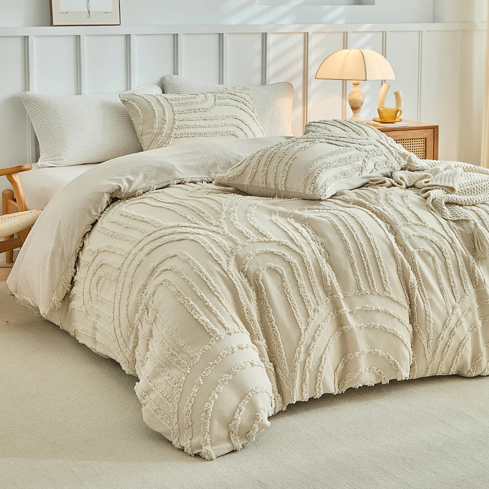 A beige embossed floral duvet cover set with matching pillowcases displayed on a bed.