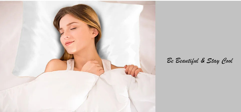 A woman rests her head on a white satin pillow, looking peaceful and beautiful.