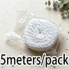 A roll of white cotton embroidered lace trim, 5 meters long, packaged in clear plastic.