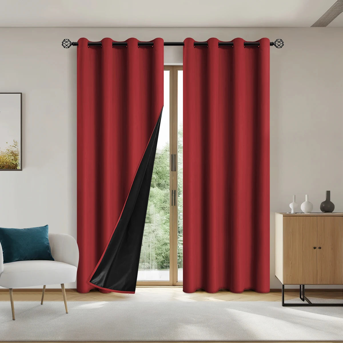 A pair of floor-length, deep red blackout curtains with black panels hanging in a modern room.
