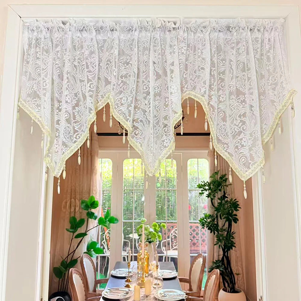 Elegant black lace curtain valance with sheer white lace and fringe draping over a window.