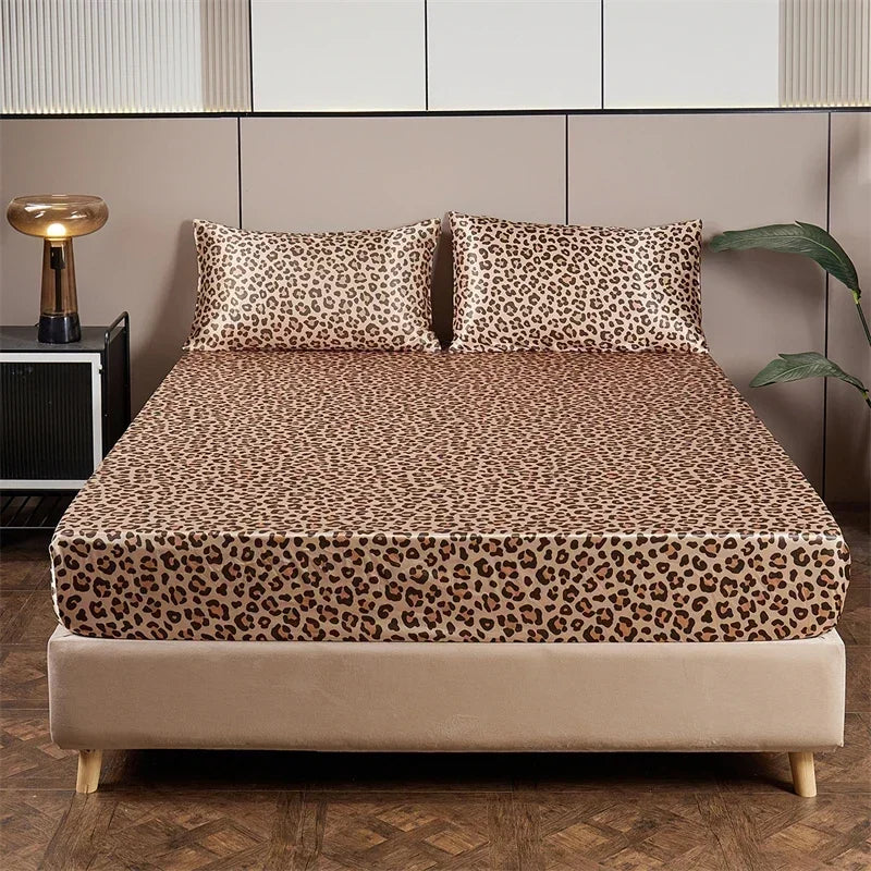 A bed featuring a leopard print satin sheet set on a modern bed with neutral tones.