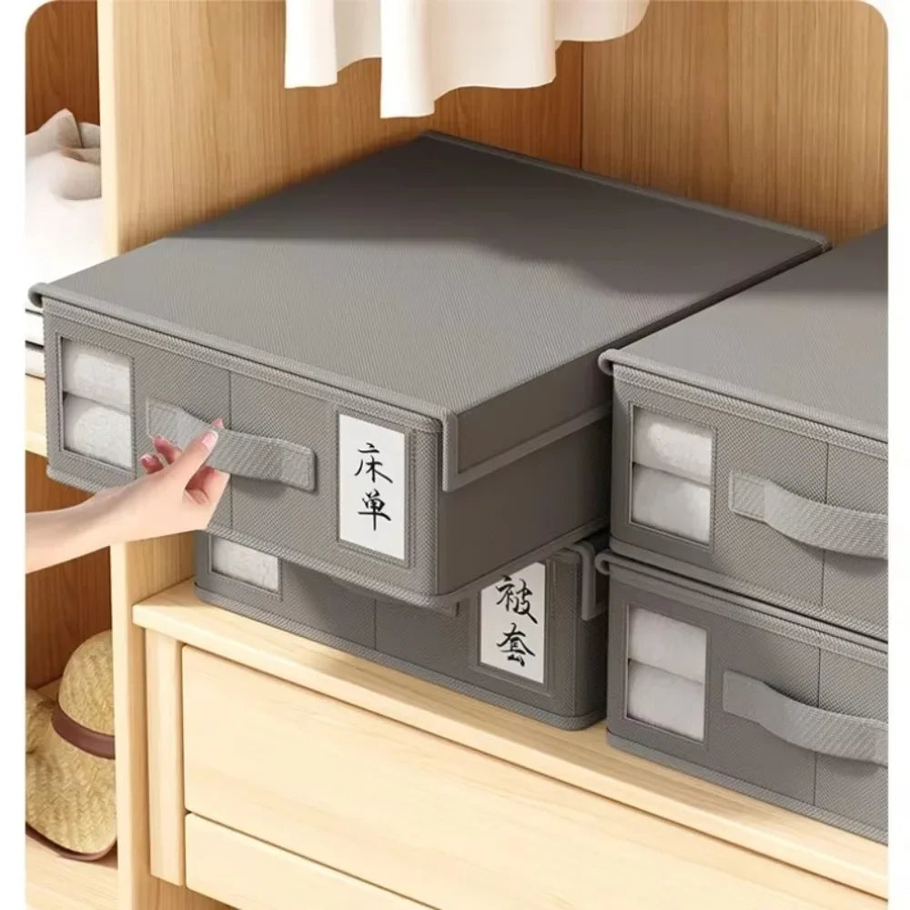 A stack of gray non-woven fabric storage boxes labeled with Japanese characters is displayed on a wooden shelf.