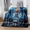 A dark blue and black blanket featuring a portrait of a football player in a jersey.