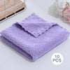 A stack of ten purple velvet cleaning face towels is displayed on a white surface.