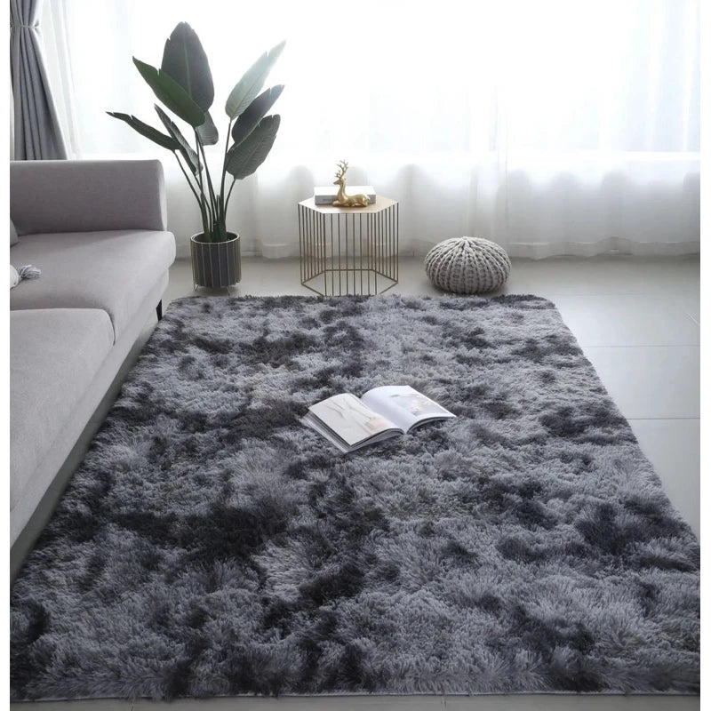 A gray luxury velvet anti-slip floor mat placed on a white floor near a window with a potted plant and decorative objects.