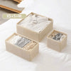 A set of beige foldable underwear organizers for XS to M sizes, showing neatly folded garments on a white surface.