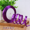 Roll of purple satin ribbon used for crafting or decoration