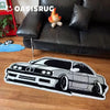 A black and white graphic carpet featuring a sports car design on a wooden floor.