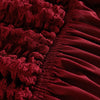 Close-up of a deep red stretch knit sofa cover featuring a textured bubble lattice pattern.