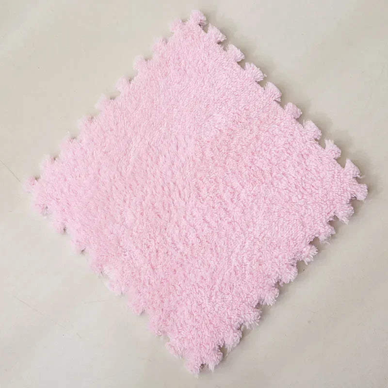 A square pink plush interlocking puzzle rug mat with a textured surface.