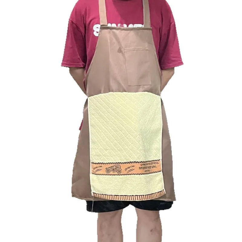 A person is wearing a beige apron over a pink shirt, featuring a light yellow quilted pocket with orange embroidery.