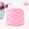 Pink N3 chunky velvet knitting yarn ball with a purple flower in the background