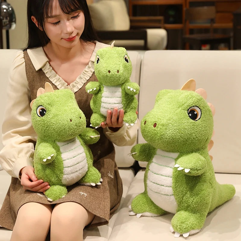 A young woman is holding several soft green dinosaur plush toys.