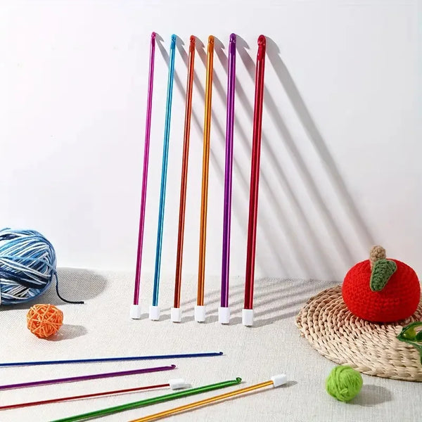 A collection of colorful stainless steel crochet hooks in various sizes and colors displayed on a white surface.