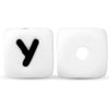 Two white silicone alphabet beads, one showing the letter Y and the other blank.