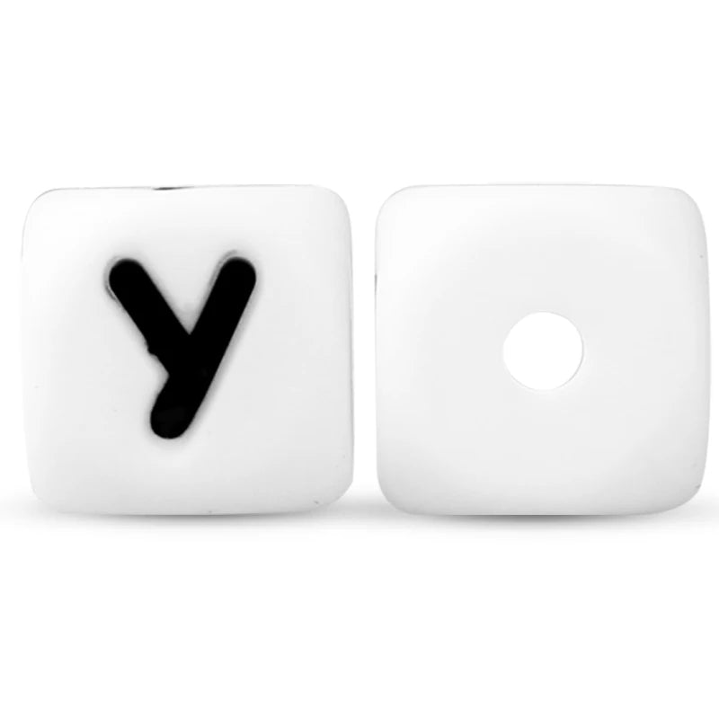 Two white silicone alphabet beads, one showing the letter Y and the other blank.