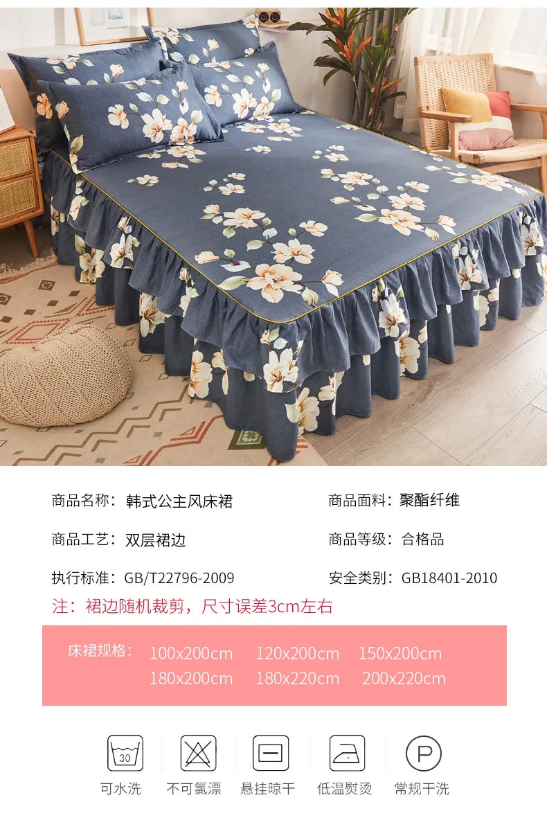 A dark blue printed bed skirt with a ruffled hem and floral pattern displayed on a bed.