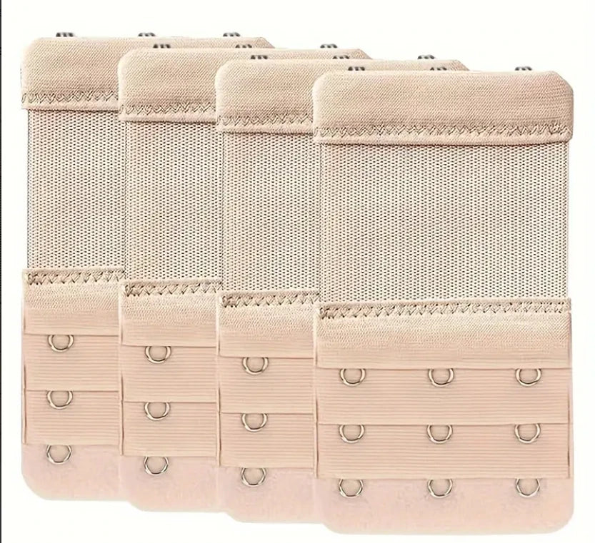 A pack of four beige silicone bra strap extenders with adjustable clips.