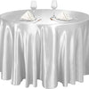 A silver satin round table cloth set with glassware and silverware for elegant decor.