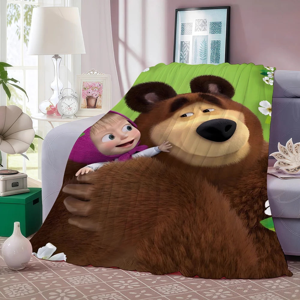 A cartoon bear character with a small child sleeping on a green patterned fleece blanket.