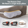 A gray ergonomic knee pillow is shown being used by a person lying on their side.