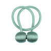 A pair of light mint green magnetic curtain tiebacks with twisted cord handles.