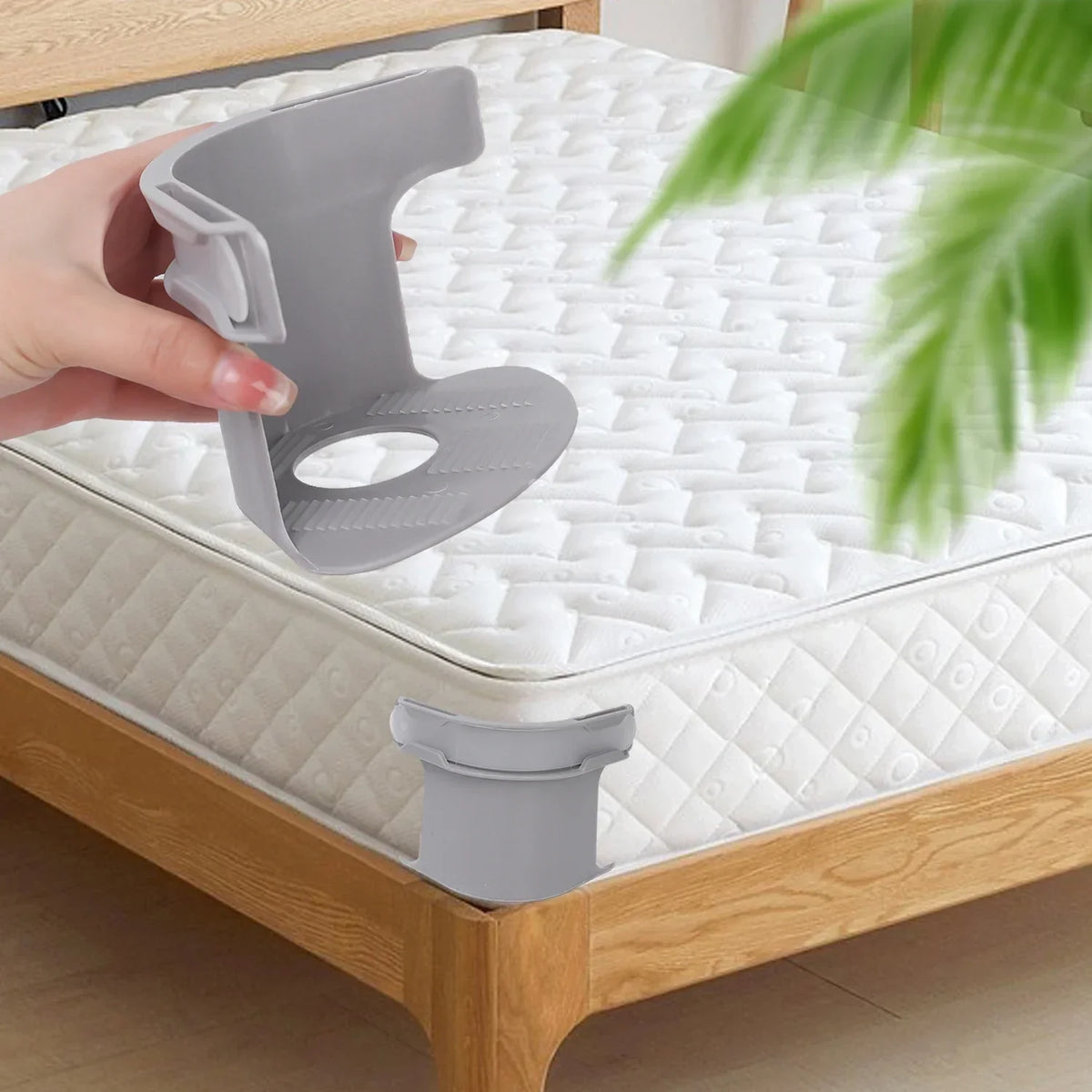 A hand is placing an invisible corner tightener clip onto a quilted mattress surface.
