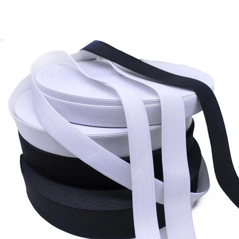 Stack of white and black adjustable elastic bands for garments