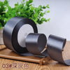 Roll of dark gray satin ribbon for gift wrapping and DIY crafts