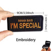 A black embroidered patch with the text Mama Says I'm Special is shown being held by a hand.