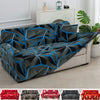 A stretchable festive sofa cover with a geometric pattern in shades of gray and blue on a white sofa.
