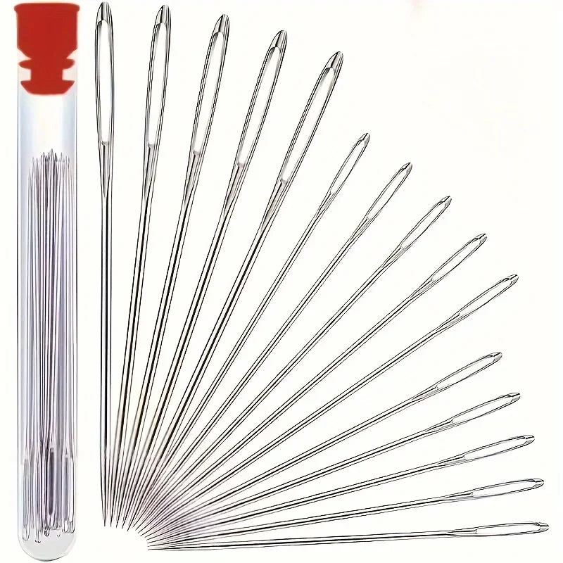 A set of silver sewing needles arranged radially inside a red storage box.