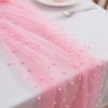 Pink pearl beaded tulle table runner draped on a white tablecloth.