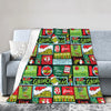 A colorful Christmas themed plaid throw blanket draped over a gray sofa.