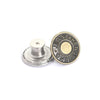 A round metal button with the name Jean Sheng engraved on it.