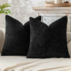 A black textured chenille pillow cover with a minimalist design resting on a light-colored surface.