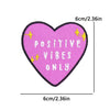 Pink heart shaped embroidery patch with yellow sparkles and the text POSITIVE VIBES ONLY