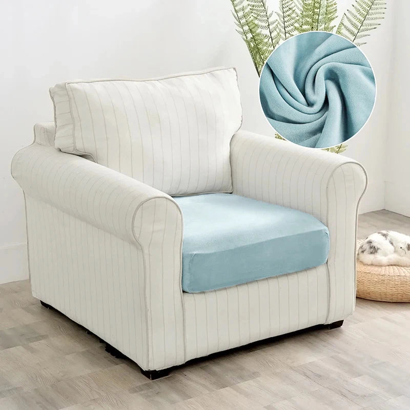 A cream upholstered armchair with light blue seat covers and a circular swatch of blue velvet fabric.
