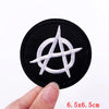 Black embroidered patch featuring a white stylized skull design